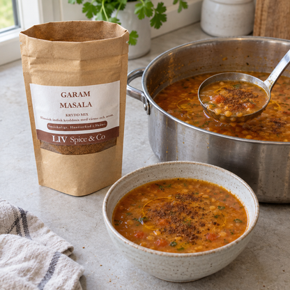Open Garam Masala pouch beside a pot of thin red lentil soup